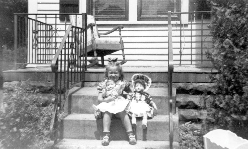 Marianne as a little girl, on the porch of her grandmother’s Roblyn Avenue home. (Photo courtesy Marianne McNamara)